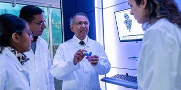 Dr. Sriram Subramaniam (left in first photo) works with students in his lab.