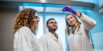 CIEBH announcement image featuring Dr. Anna Blakney and team of researchers in white lab coats at UBC